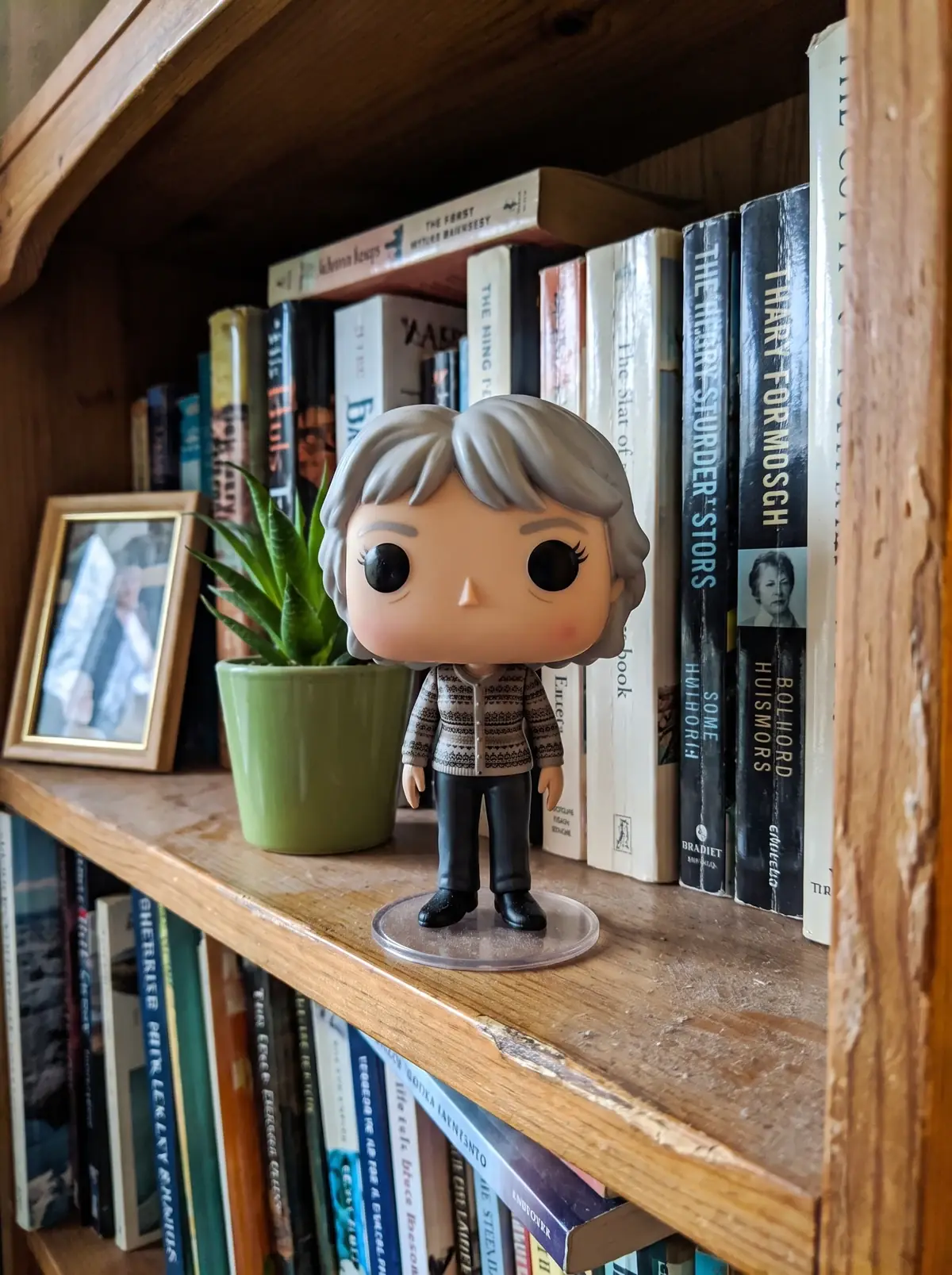 The figurine printed from it: in her living room, in a patterned cardigan.