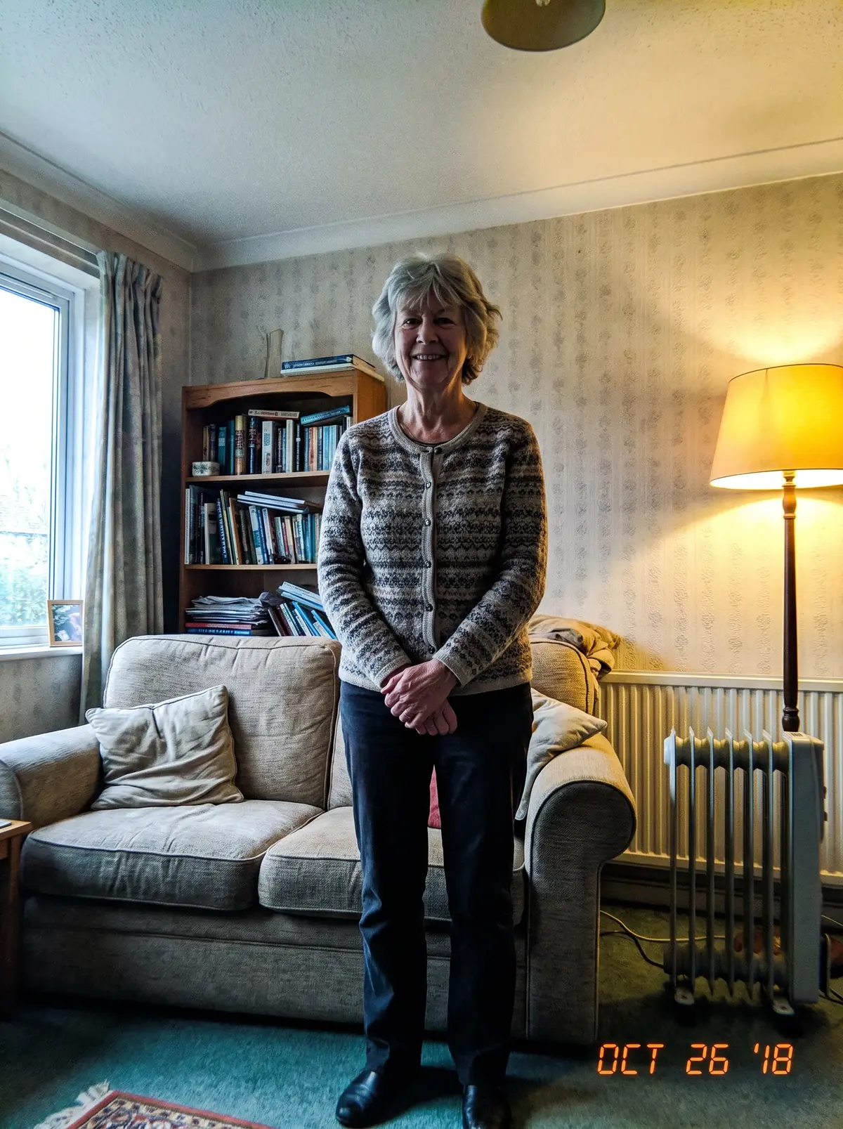 The photo we worked from: in her living room, in a patterned cardigan.